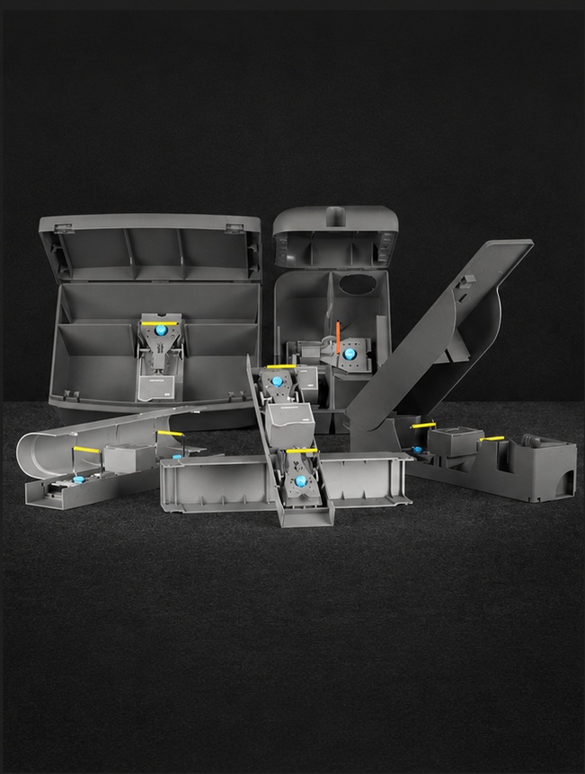 Group of gray modular plastic housings with blue knobs and yellow latches on a dark surface.